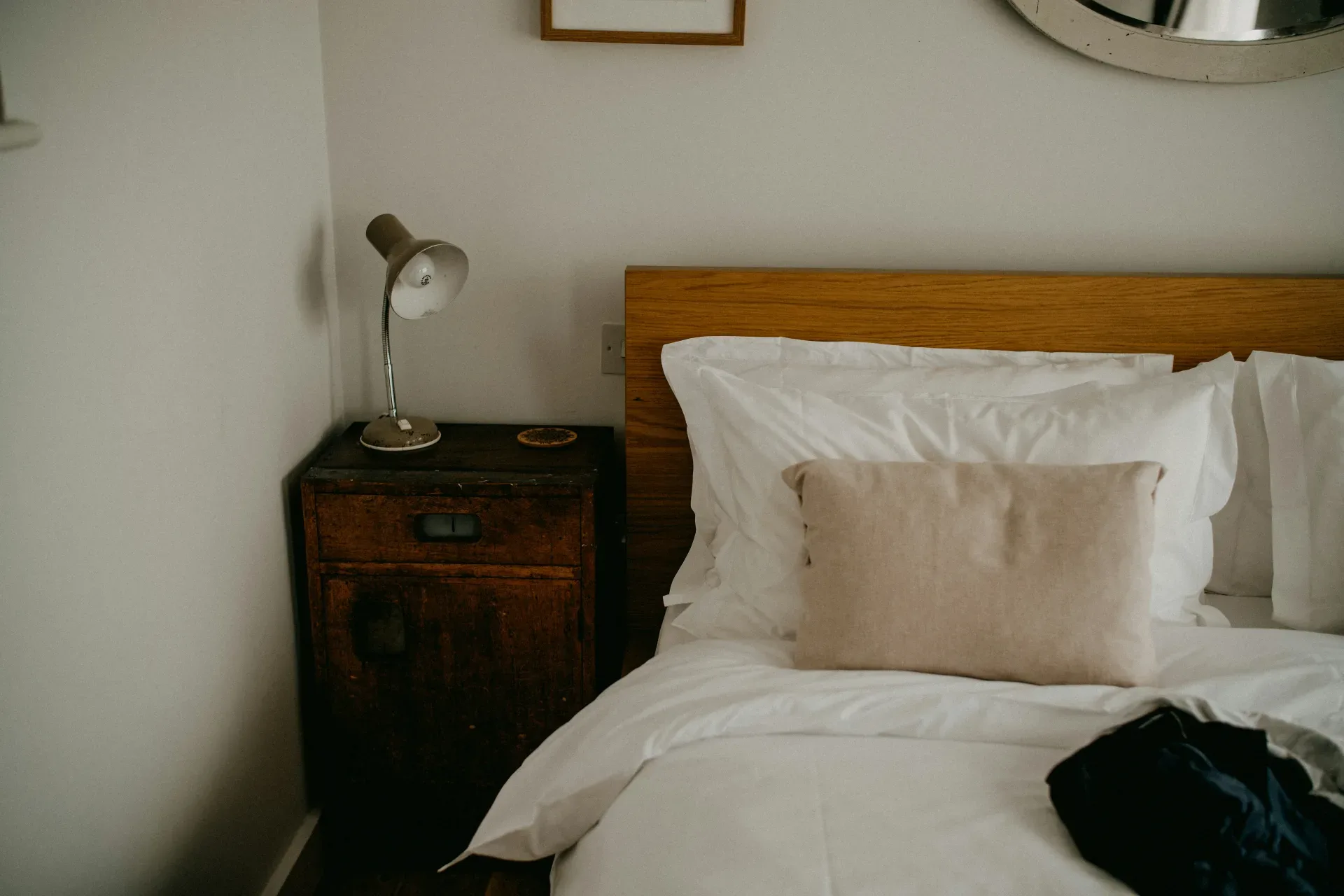 A cozy bedroom with a made bed and bedside table.