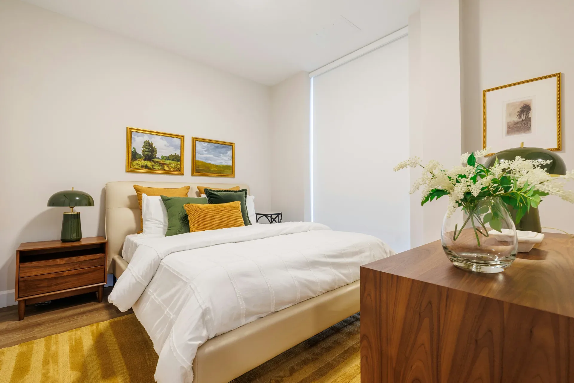 A modern bedroom with a bed and artwork.