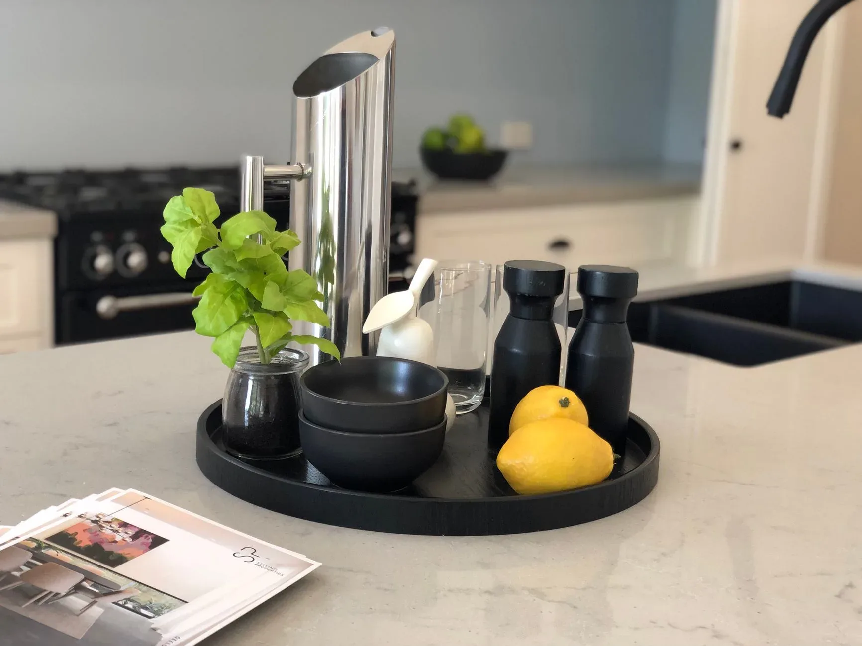 A modern kitchen counter setup with fresh lemons and elegant kitchenware.