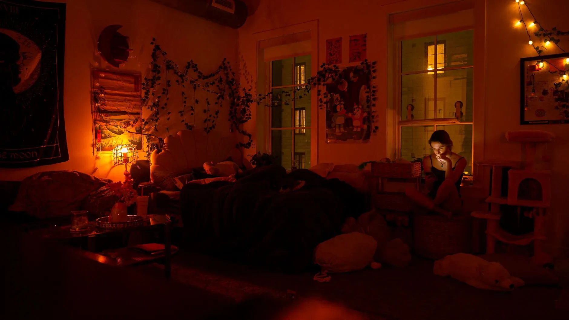 A serene bedroom scene with warm lighting and a person using a smartphone, creating a cozy atmosphere.