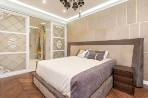 A stylish and elegant bedroom featuring modern interior design elements with luxurious decor and soft lighting.