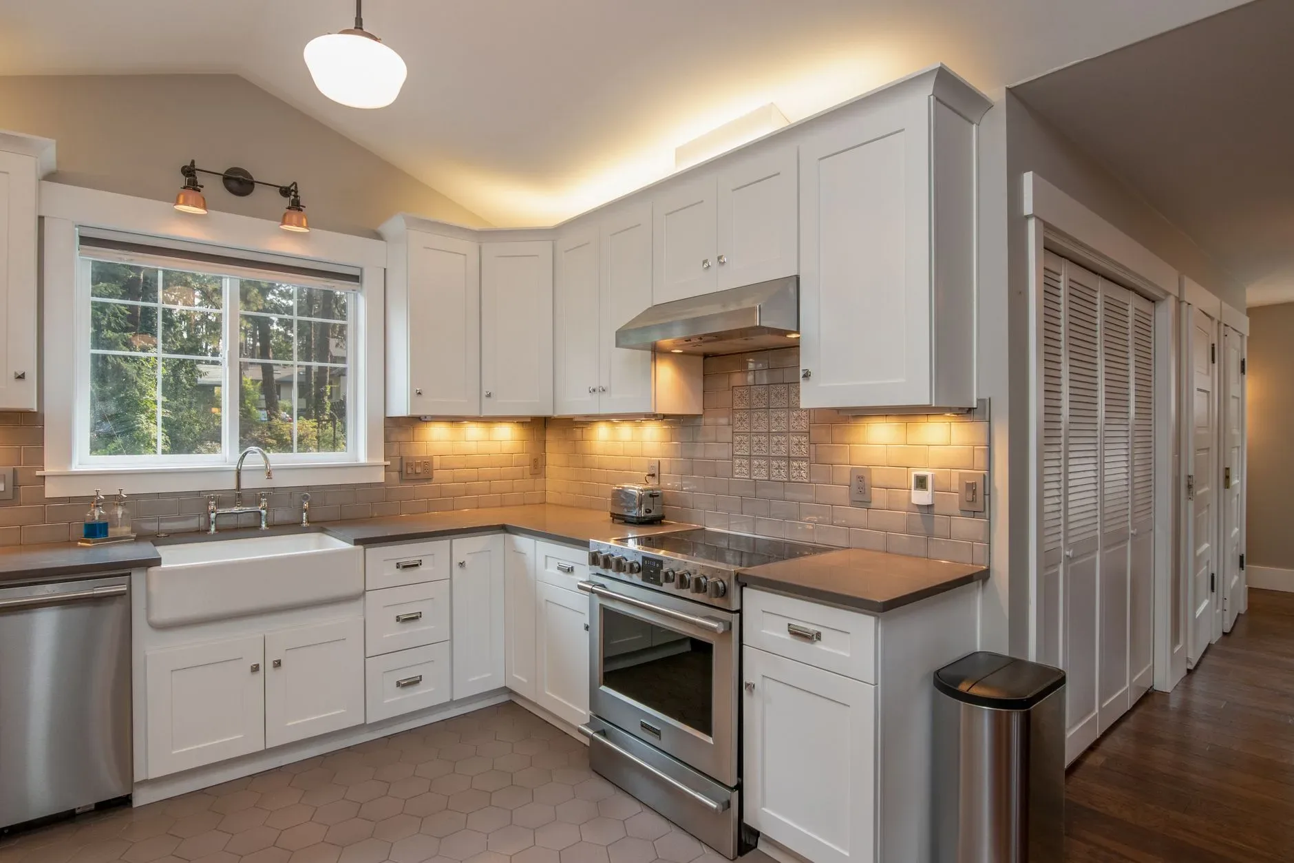 Bright and spacious kitchen with white cabinetry and sleek appliances.