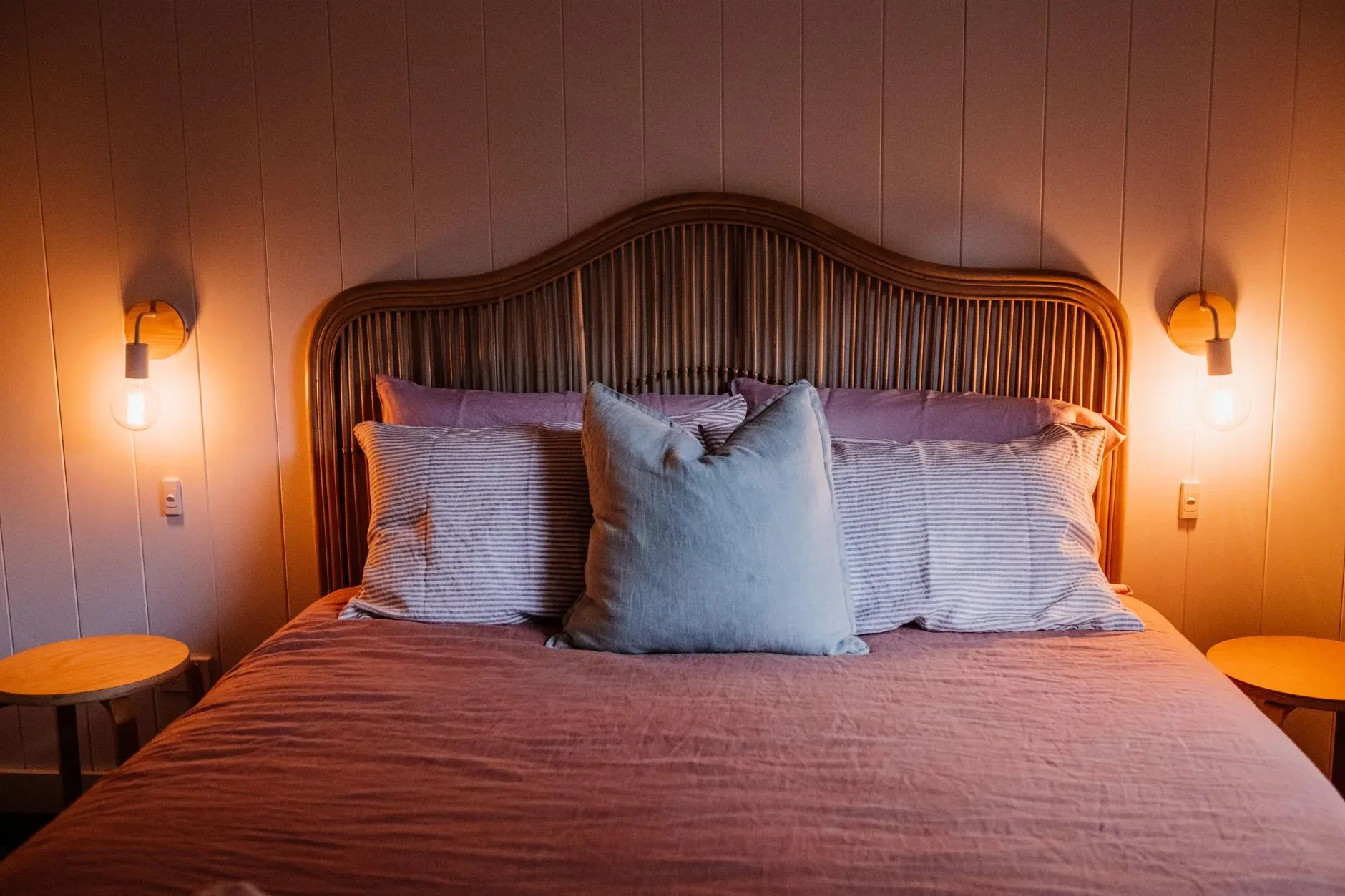 Elegant bedroom scene featuring a stylish bed with soft lighting creating a cozy atmosphere.