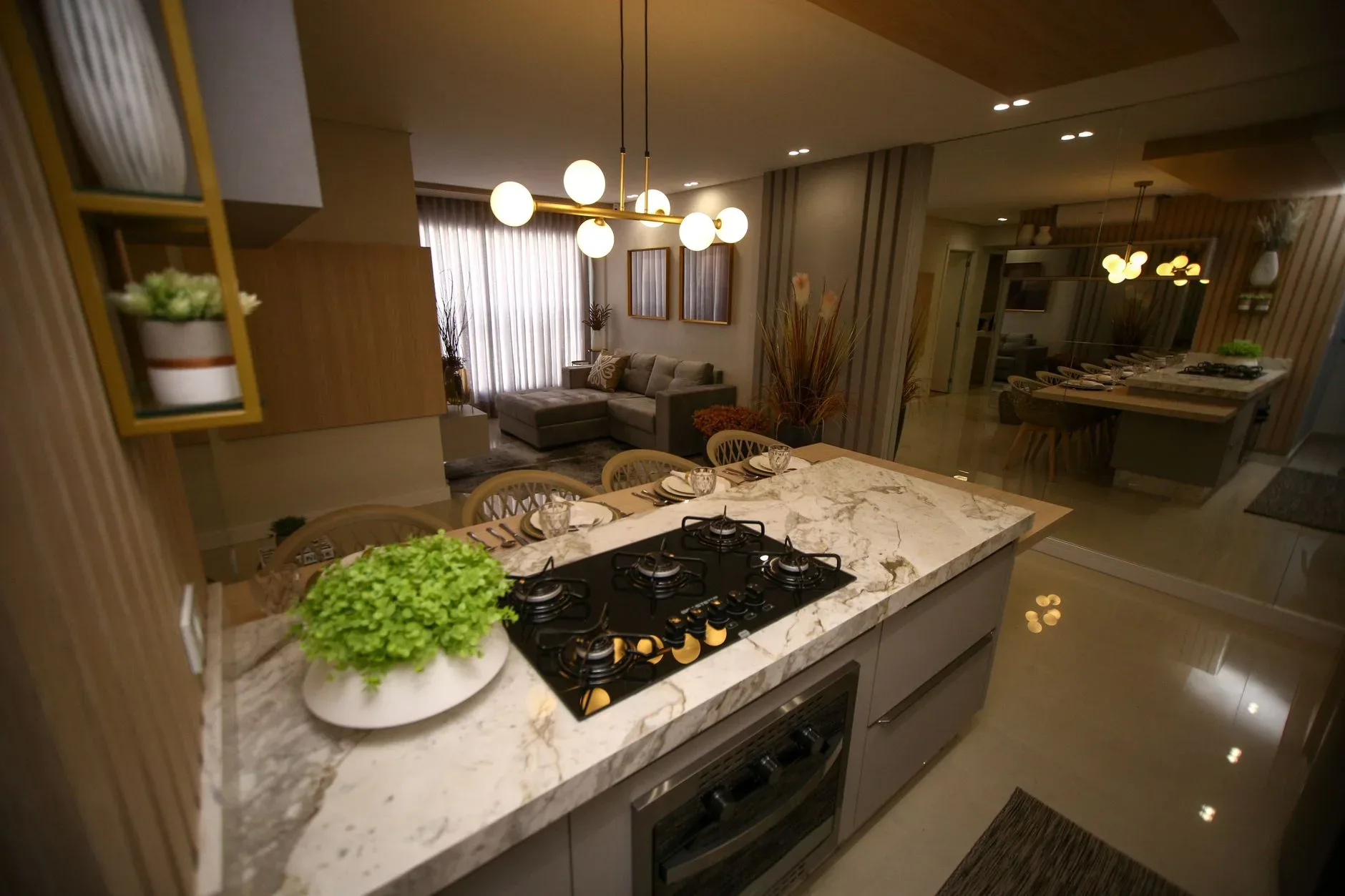 Elegant kitchen interior with marble countertops, modern decor, and gas stove setting.