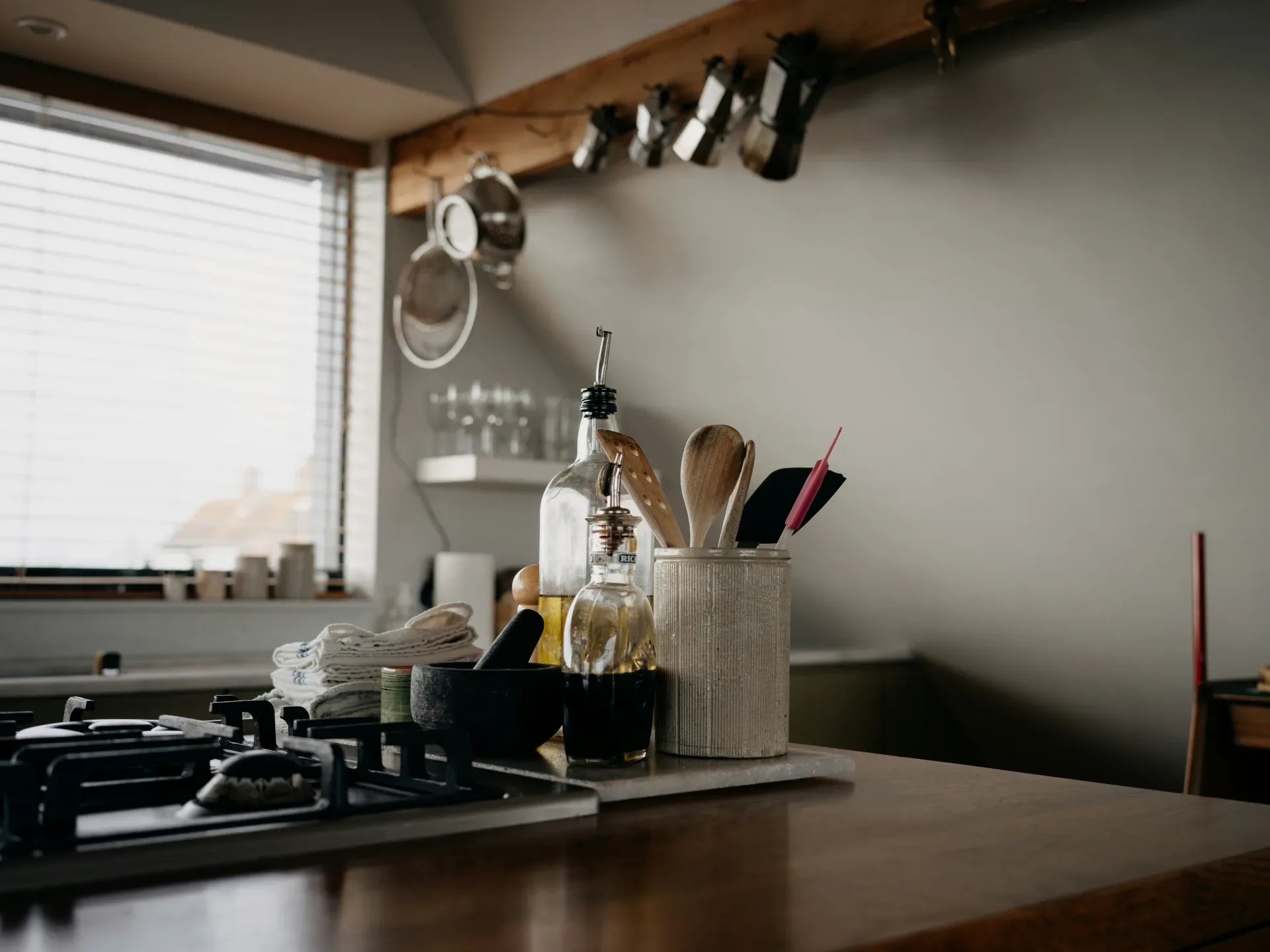 Kitchen counter with cooking utensils and bottles.