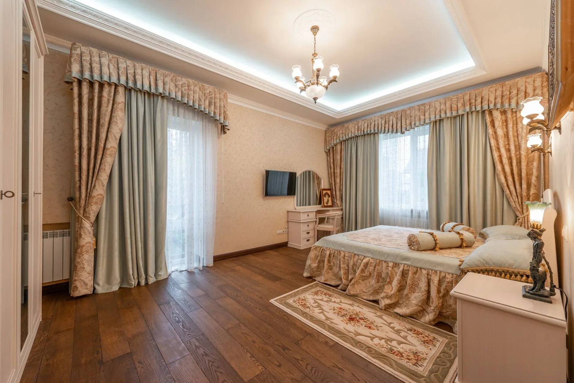 Luxurious classic bedroom with ornate curtains and furnishings.