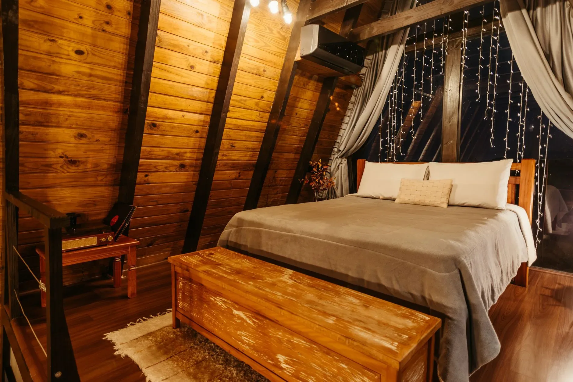 Warm, inviting wooden bedroom setting at an inn in Santa Teresa, Brazil.