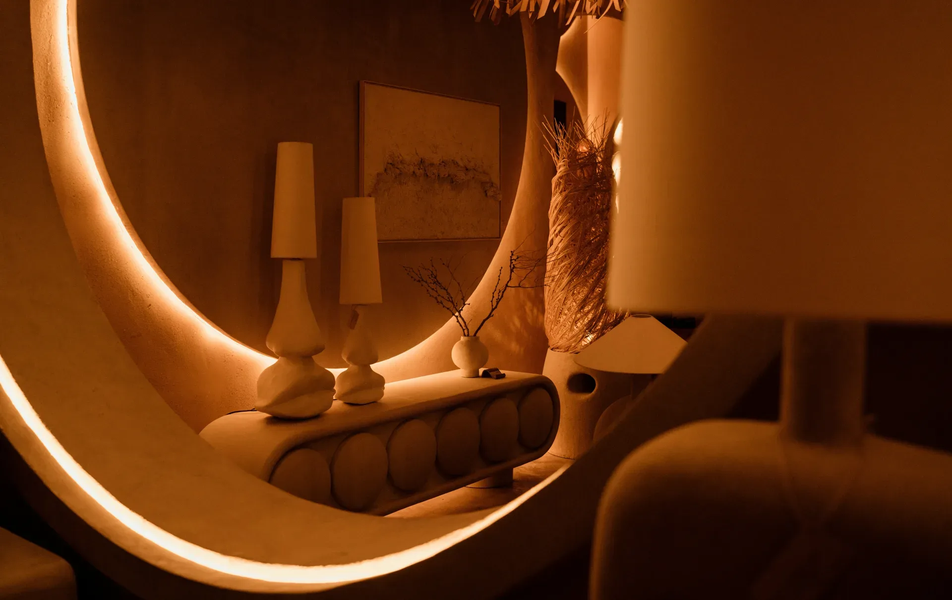 a room with a large mirror and a lamp